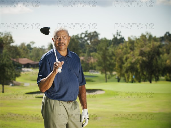 Black man playing golf