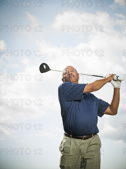 Black man playing golf