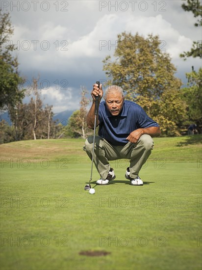 Black man playing golf