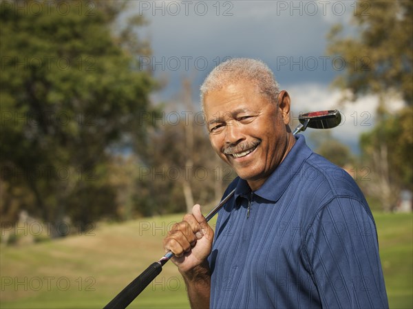 Black man playing golf