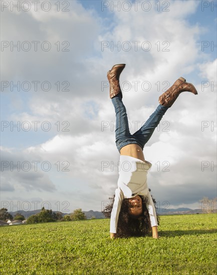 Mixed race girl doing cartwheel