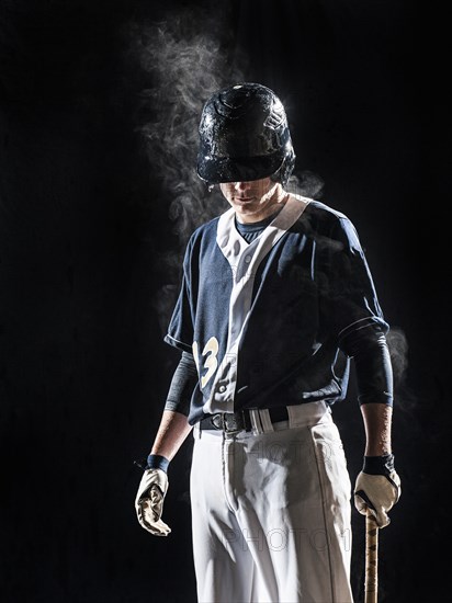 Caucasian baseball player standing under lights