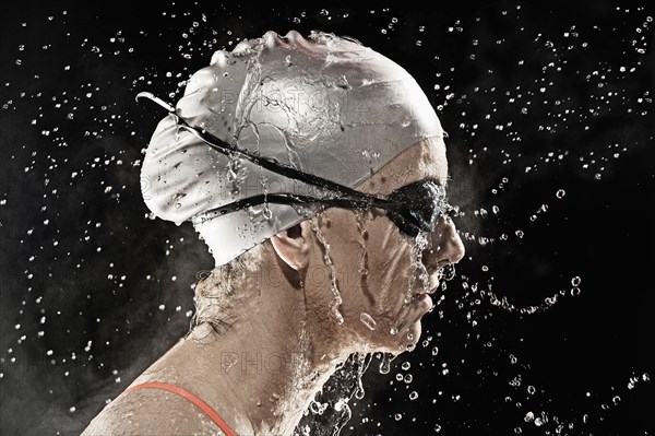 Caucasian swimmer standing in rain