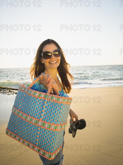 Mixed race woman walking on beach