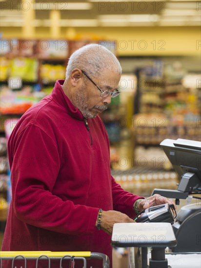 African American customer at grocery store checkout