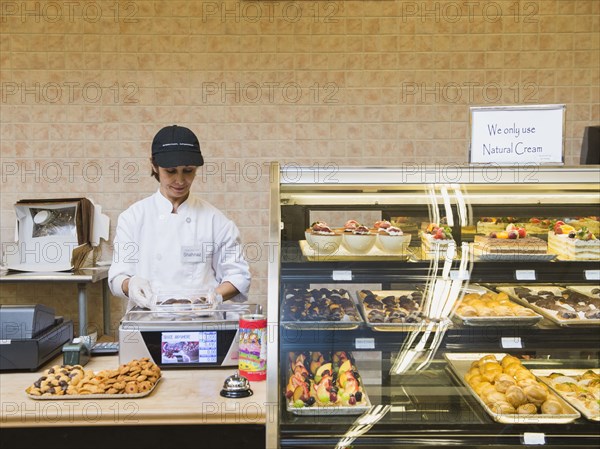 Middle Eastern woman working in bakery