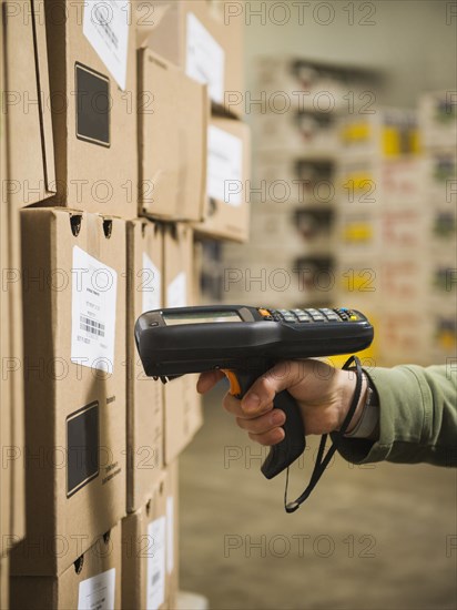 Hispanic worker scanning boxes in walk-in freezer