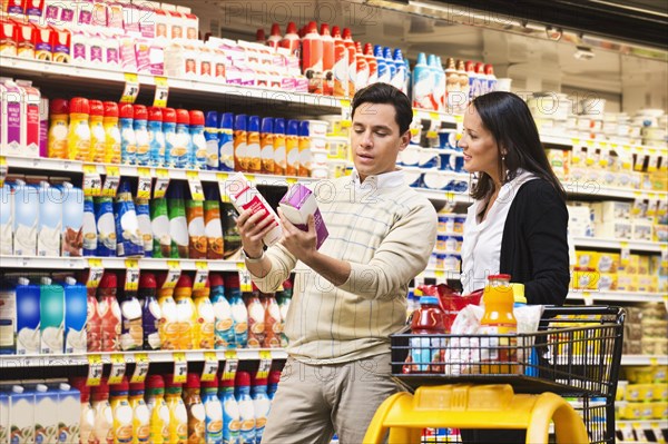 Hispanic couple shopping in grocery store