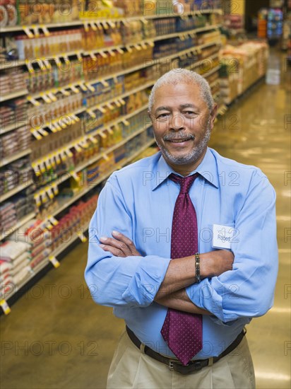 African American businessman smiling in grocery store