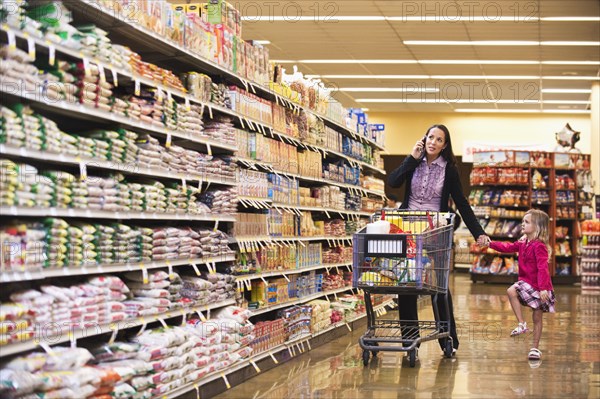 Mother and daughter shopping in grocery store