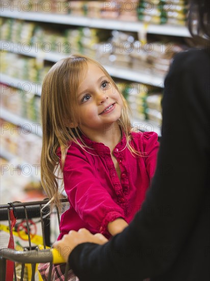 Mother and daughter shopping in grocery store