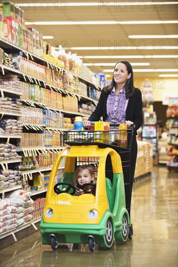 Mother and daughter shopping in grocery store