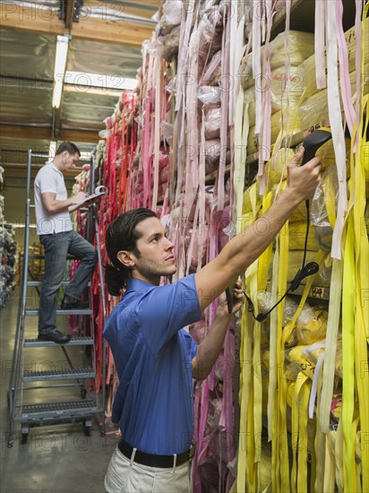 Workers examining fabric in textile factory