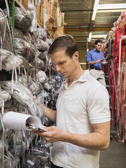 Workers examining fabric in textile factory