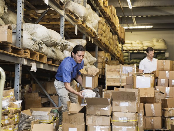 Workers stacking boxes in textile factory