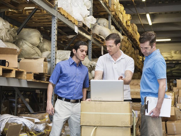 Workers stacking boxes in textile factory