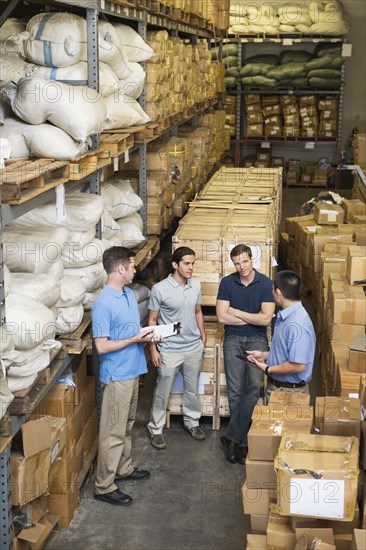 Workers talking in textile factory