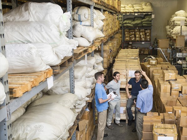 Workers talking in textile factory