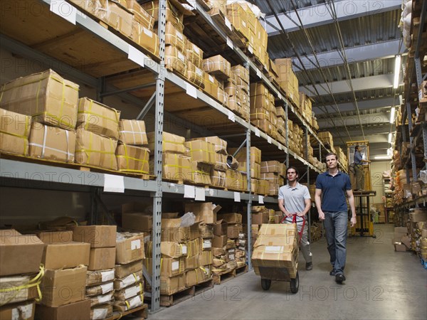 Workers carting boxes in textile factory