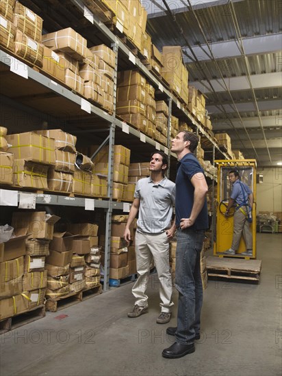 Workers examining boxes in textile factory