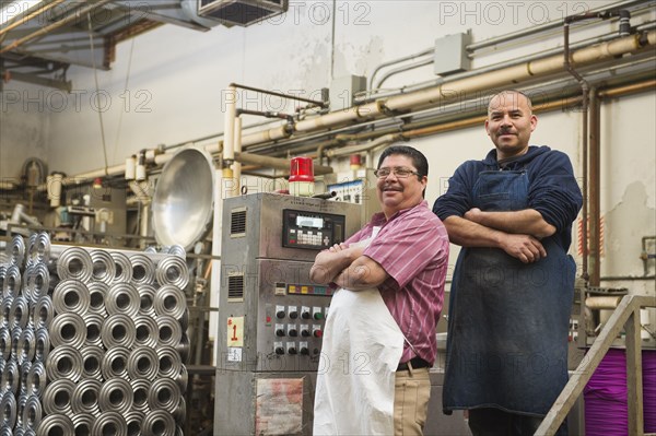 Hispanic workers smiling in textile factory