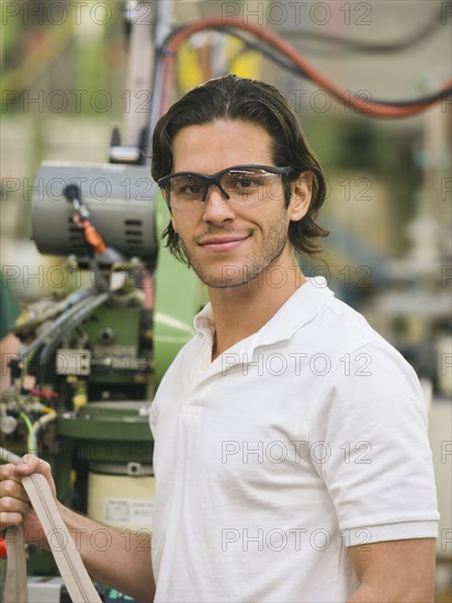 Mixed race worker smiling in textile factory