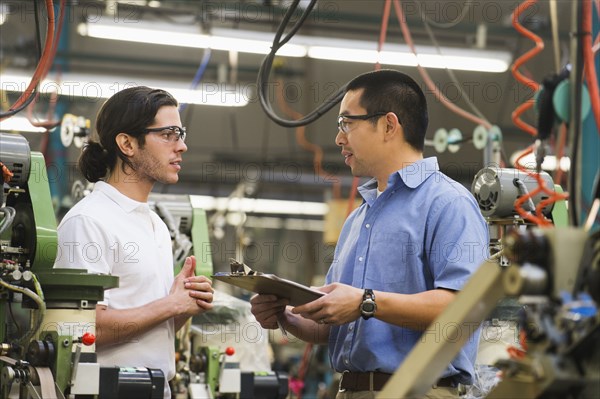 Workers talking in textile factory