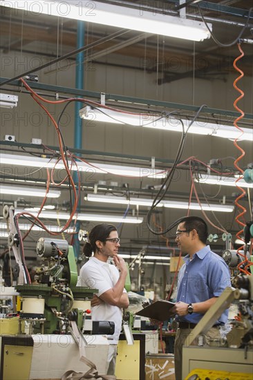 Workers talking in textile factory