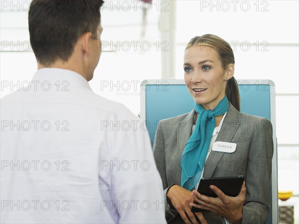 Caucasian hostess talking to businessman