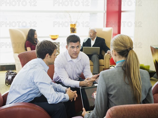 Business people talking in lobby