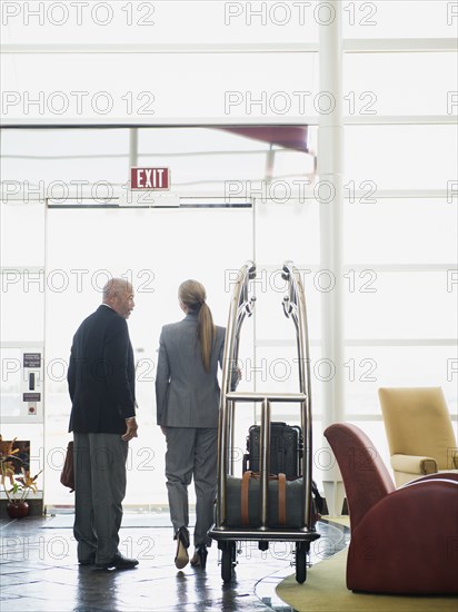 Business people talking in hotel lobby