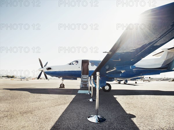 Velvet rope by airplane on runway