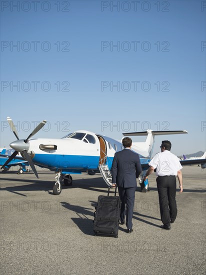 Caucasian businessmen walking on runway