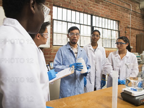 Students listening to teacher in science lab