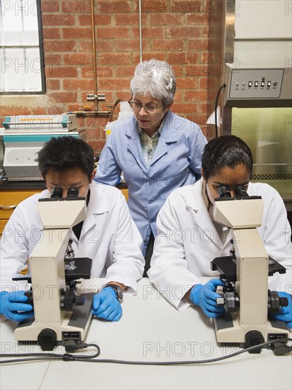 Teacher and students working in science lab