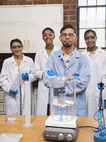 Teacher and students smiling in science lab