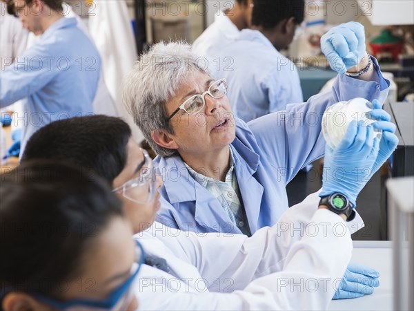 Teacher and students working in science lab