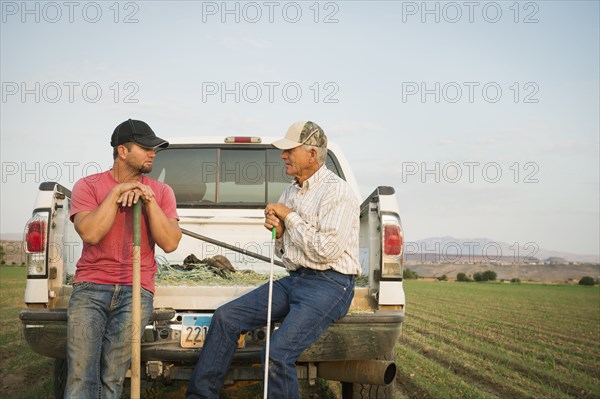 Caucasian farmers working in crop field