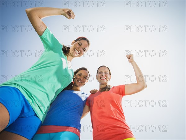 Caucasian women cheering outdoors