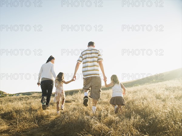 Family walking together in rural field