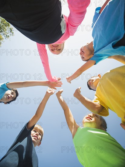 Children putting hands together outdoors