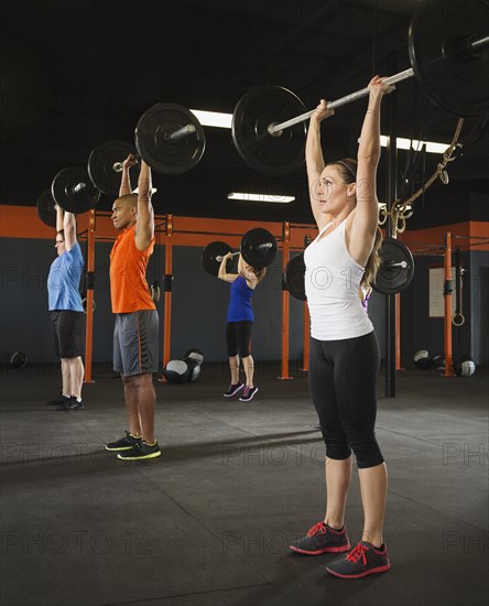 People lifting weights in gym