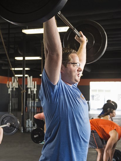 Man lifting weights in gym