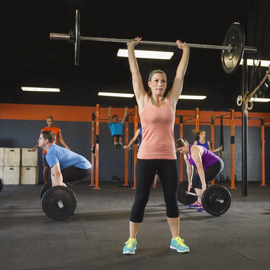 People lifting weights in gym