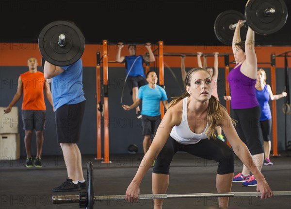 People lifting weights in gym