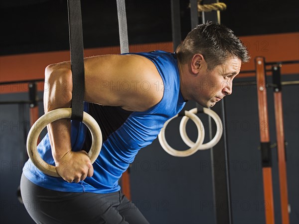 Caucasian man working out in gym