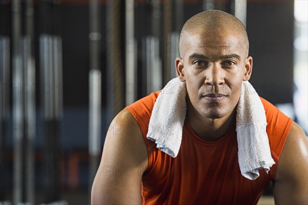 Black man resting in gym