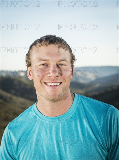 Caucasian man smiling on hilltop