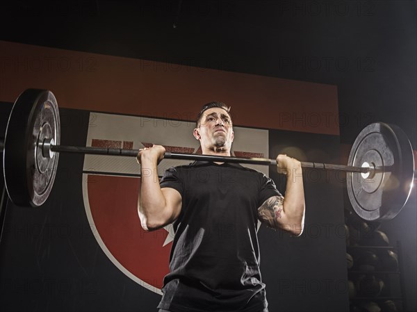 Caucasian man lifting weights in gym