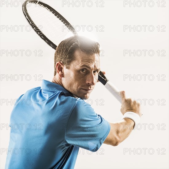 Caucasian man playing tennis
